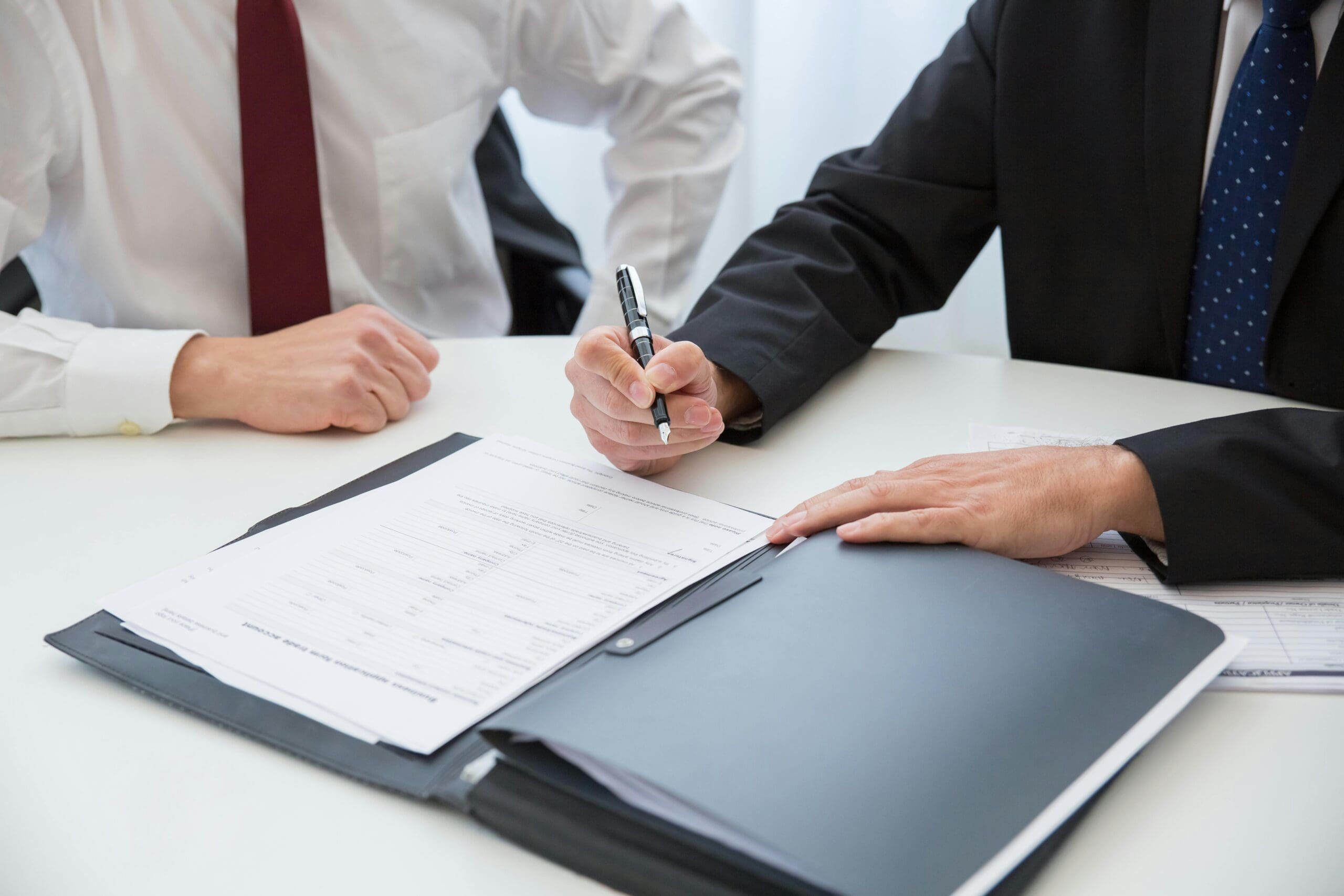 two people signing papers for business registration thailand