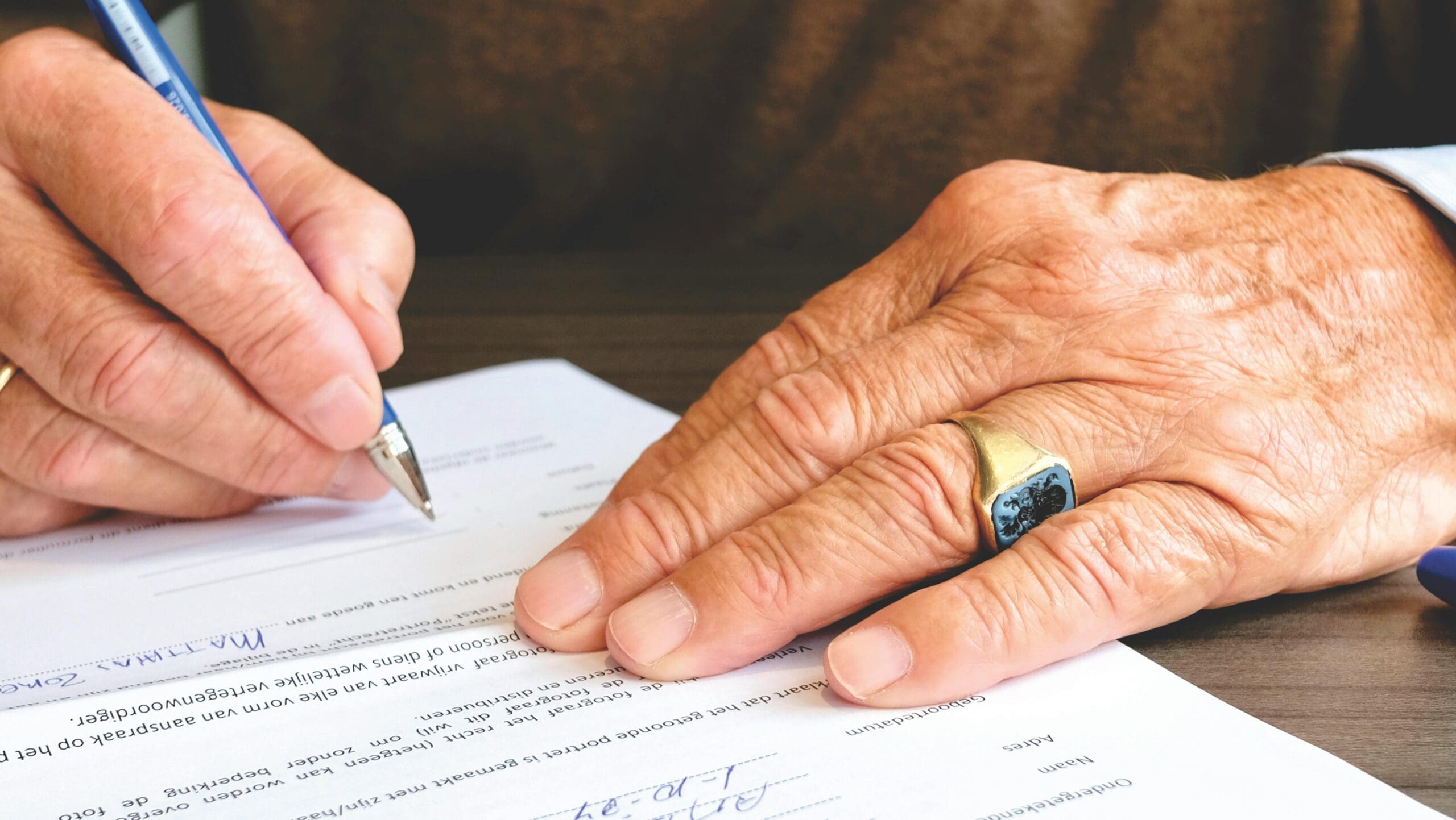 picture of notary public written on paper with a hammer.